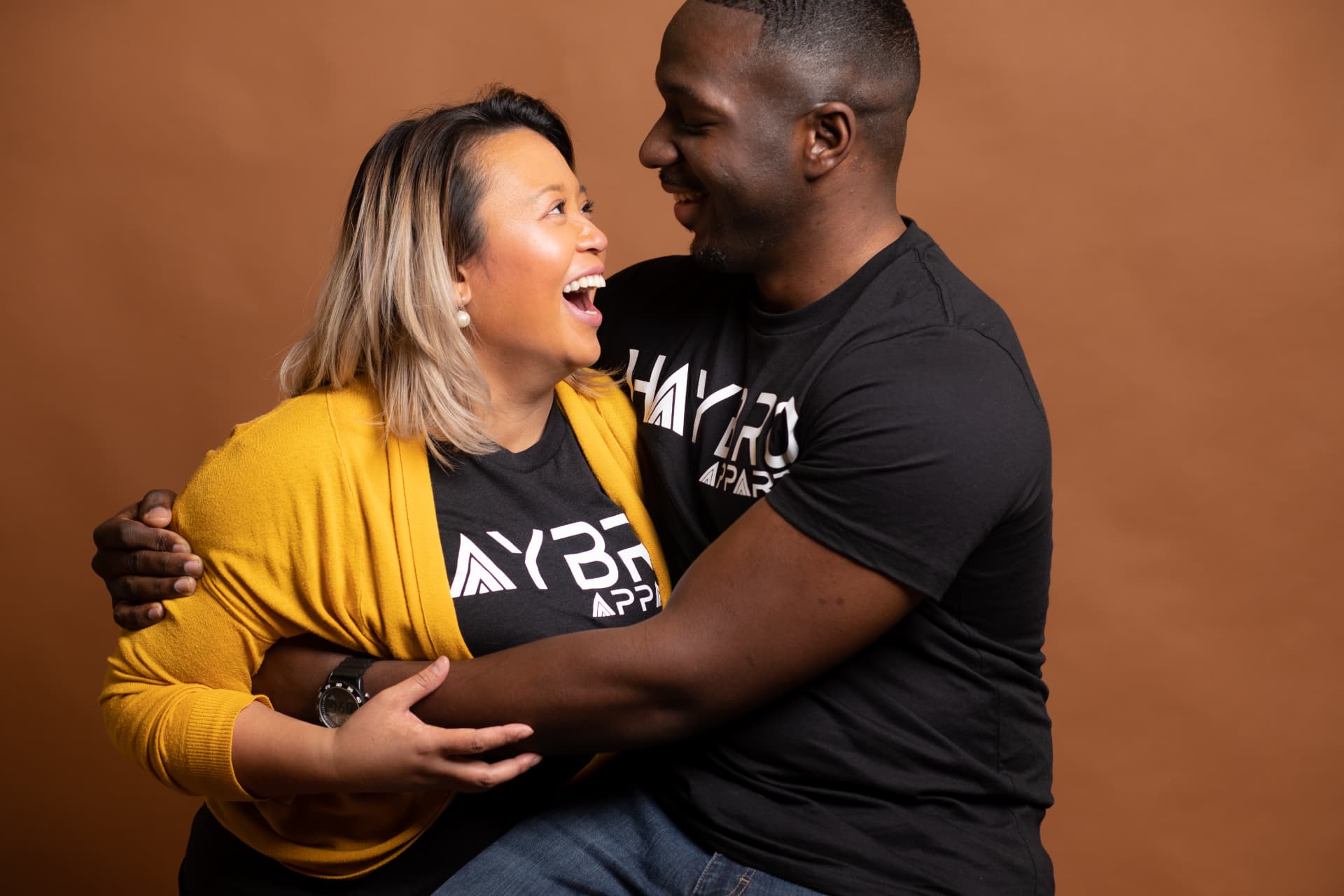 A couple laughing together during a studio branding session